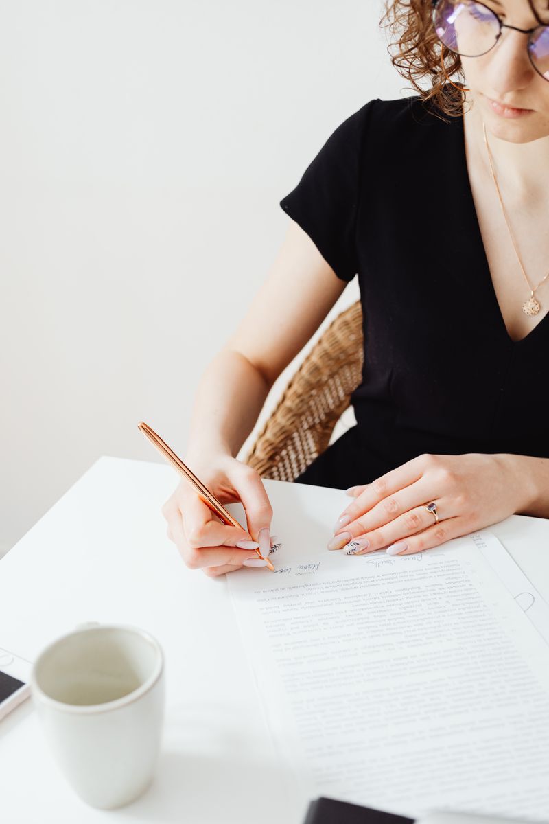 Professional signing off a document at a desk