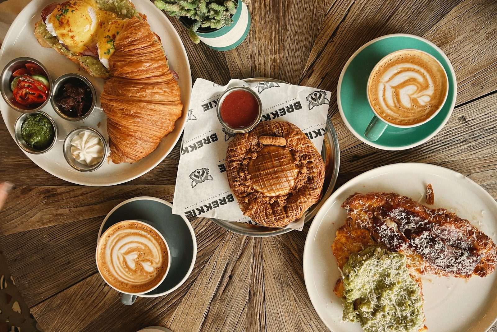 Brunch dishes and drinks laid out on a wooden table